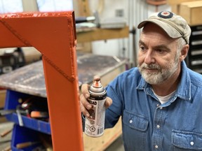 Steve Maxwell applies rust paint to a newly-made metal item in his shop. With a little bit of prep work, today’s best metal paints do not peel.