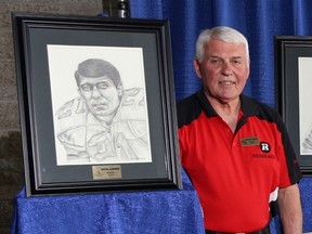 Wayne Giardino poses beside a likeness of himself at the Ottawa Sports Hall of Fame induction ceremony in 2014.