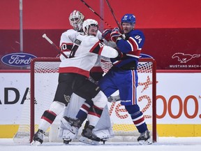 Erik Gudbranson of the Ottawa Senators and Corey Perry of the Montreal Canadiens battle for position in front of goaltender Matt Murray during the third period at the Bell Centre on February 4, 2021 in Montreal, Canada. The Ottawa Senators defeated the Montreal Canadiens 3-2.