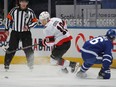 Tim Stuetzle of the Senators controls the puck as he spins away from Mitch Marner of the Maple Leafs during Monday's game in Toronto.