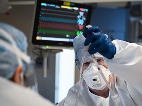 FILE: Medical staff monitor a COVID-positive patient.