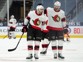 Ottawa Senators' Cedric Paquette (left) with Austin Watson, celebrate a goal on Edmonton Oilers' goaltender Mikko Koskinen in Edmonton, on Feb. 2, 2021.