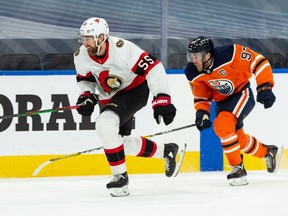 Edmonton Oilers' Connor McDavid (97) chases Ottawa Senators' Braydon Coburn (55) during third period NHL action at Rogers Place in Edmonton, on Tuesday, Feb. 2, 2021.