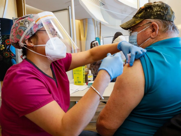  FILE: Greg Colbourne receives his first dose of the Pfizer COVID-19 vaccine from nurse Angelita Angeles at the Wabano Centre for Aboriginal Health, in partnership with Ottawa Public Health, during a vaccination clinic for members of the Indigenous community who are 70 and older and live in Ottawa.