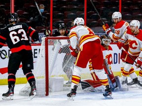 Ottawa Senators center Colin White (36) and right wing Evgenii Dadonov (63) celebrate a goal against the Calgary Flames during third period action against the Calgary Flames at the Canadian Tire Centre on Thursday.