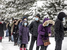 Eligible vaccine recipients, mostly frontline workers, lined up outside The Ottawa Hospital Civic Campus, Saturday Feb. 27, 2021, in the snowstorm that hit the capital, to receive their much anticipated COVID-19 vaccine.