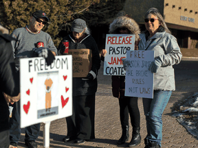 Supporters protest as Pastor James Coates of GraceLife Church appears in court after he was arrested for holding Sunday services in violation of COVID-19 rules, in Stony Plain, Alta., on Wednesday, February 24, 2021.