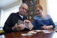 Paul Grisham and his wife, Carole Salazar, look over his wallet and the items that were inside when he lost the wallet.