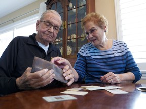 Paul Grisham and his wife, Carole Salazar, look over his wallet and the items that were inside when he lost the wallet.