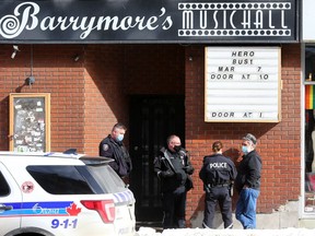 OTTAWA - February 18, 2021 -- Landlord Louis Antonakos talks with police officers after they were called to a dispute between the owner of Barrymore's and Antonakos.