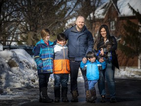 From left: 11-year-old Luca, nine-year-old Joey, Tony, four-year-old Santino, Lyana Colasante and the new family dog Groot on Sunday, Feb. 28, 2021, outside their south-end home. The family painted a giant thank you to hospital staff, and it is now hanging in the COVID ward at the Civic campus.