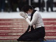 (FILES) In this file photo taken on July 19, 2020, Myanmar's State Counsellor and Foreign Minister Aung San Suu Kyi wears gloves and a face mask as she pays her respects to her late father during a ceremony to mark the 73rd anniversary of Martyrs' Day in Yangon. - A Myanmar court has charged ousted leader Aung San Suu Kyi with breaching an import and export law, a spokesperson from her National League for Democracy (NLD) said on February 3, 2021.