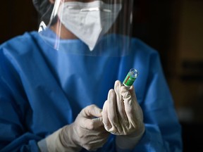 A health worker prepares to give a dose of Covid-19 coronavirus vaccine.