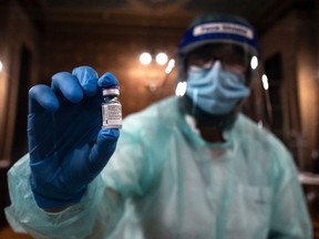 A medical worker shows a dose of the Pfizer-BioNTech Covid-19 vaccine.