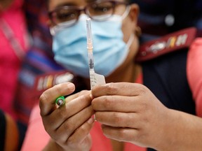 A healthcare worker holds the Johnson & Johnson vaccine.