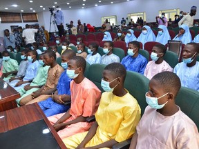 Abducted students of Government Science College Kagara sit in the state conference hall after being freed in Minna, Niger State, central Nigeria, on Saturday. A day after more than 300 schoolgirls were abducted by gunmen in the northwest.