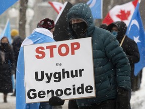 Demonstrators gather outside the Parliament buildings Feb. 22 in advance of an opposition motion calling on Canada to recognize China's actions against ethnic Muslim Uyghurs as genocide.