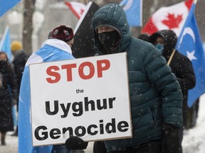 Protesters gather outside the Parliament buildings in Ottawa, Monday, February 22, 2021.