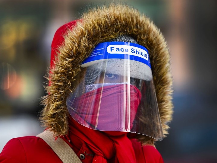  FILE: A woman bundles up in the cold weather wearing her PPE during the COVID-19 pandemic.