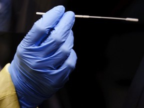 FILE: A medical worker take a COVID-19 swab.