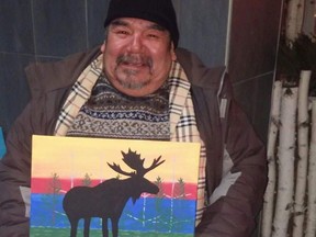 Photo of artist Donnell Taylor, at his usual spot on Elgin Street with his painting called "Reflection of Life".