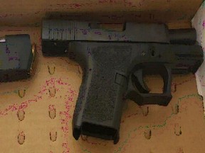 A handgun seized by Ottawa police in a raid, which resulted in the arrest of four people and the seizure of two handguns, fentanyl, cocaine and other narcotics.