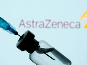 FILE PHOTO: A vial and syringe are seen in front of a displayed AstraZeneca logo in this illustration taken January 11, 2021.