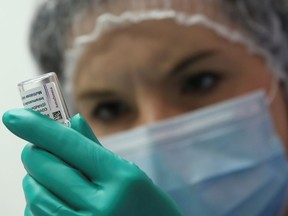 FILE: A medical worker prepares a dose of AstraZeneca's COVID-19 vaccine.