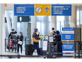 Passengers wait to be tested after they arrive at Toronto's Pearson airport after mandatory coronavirus disease (COVID-19) testing took effect for international arrivals in Canada.