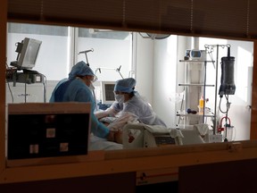 Medical staff members work in an Intensive Care Unit (ICU) for COVID-19 patients.