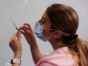 FILE PHOTO: A medical worker prepares to administer a second vaccination injection against the coronavirus disease as Israel continues its national vaccination drive.