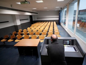 FILE: A professor records his lesson in an empty classroom to stream it online for his students.