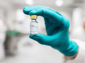 FILE PHOTO: A lab worker holds a vial of Johnson & Johnson's COVID-19 vaccine .