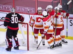 Senators goaltender Matt Murray (30) stands in his crease as Calgary Flames left wing Andrew Mangiapane (88), left to right, defenceman Rasmus Andersson (4), Matthew Tkachuk (19), Mikael Backlund (11) and Mark Giordano (5) celebrate a goal during second period NHL action in Ottawa on Saturday, Feb. 27, 2021.