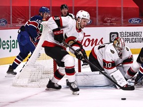 Ottawa Senators center Josh Norris helps goaltender Matt Murray to make a save against Montreal Canadiens during the first period at Bell Centre, Feb. 4, 2021.