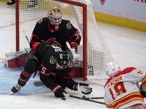 Ottawa Senators Joey Daccord watches defenceman Mike Reilly block a shot by Calgary Flames left wing Matthew Tkachuk in the third period at the Canadian Tire Centre on Saturday.