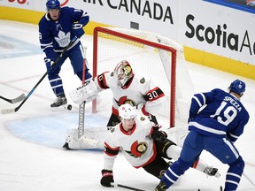 Ottawa Senators goalie Matt Murray blocks a shot from Toronto Maple Leafs forward Jason Spezza as Leafs forward Mitchell Marner looks for a rebound in the second period at Scotiabank Arena on Thursday.