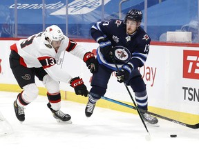 Ottawa Senators left wing Nick Paul chases down Winnipeg Jets left wing Pierre-Luc Dubois in the second period at Bell MTS Place on Feb 21, 2021.