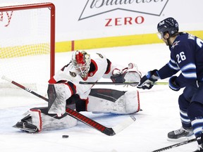 Ottawa Senators goaltender Marcus Hogberg blocks a shot from Winnipeg Jets right wing Blake Wheeler in the third period at Bell MTS Place, Feb. 11, 2021.