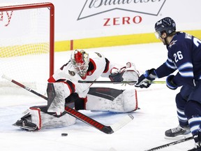 Feb 11, 2021; Winnipeg, Manitoba, CAN; 

Ottawa Senators goaltender Marcus Hogberg blocks a shot from Winnipeg Jets right wing Blake Wheeler at Bell MTS Place on Thursday.