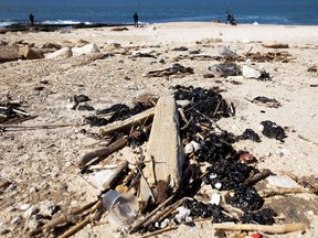 Clumps of tar are seen on the sand an after an offshore oil spill drenched much of Israel's Mediterranean shoreline with tar, at a beach in Ashdod, southern Israel on Saturday.