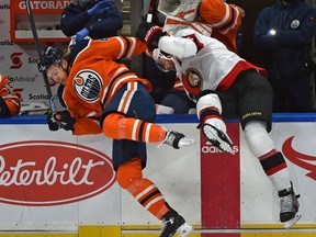 Edmonton Oilers William Lagesson (84) and Ottawa Senators Erik Gudbranson (44) almost go in to the bench as hitting each other during NHL action at Rogers Place in Edmonton, January 31, 2021.
