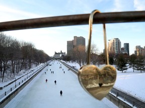 Skaters take to the Rideau Canal Skateway behind one of the "locks of love" placed on the Corktown Bridge on a mild February day in Ottawa. The canal is closed for the season, alas.
