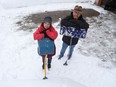 Dan Cameron and his wife Brenda clear snow from their driveway on Tuesday, Feb. 23, 2021.