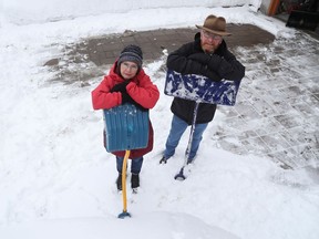 Dan Cameron and his wife Brenda clear snow from their driveway on Tuesday, Feb. 23, 2021.
