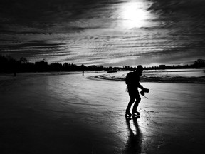 A man skates through the early morning light on Dow's Lake in Ottawa.