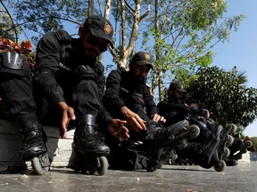 Special Security Unit (SSU) police members put on their rollerblades during practice at the headquarters in Karachi, Pakistan February 18, 2021.