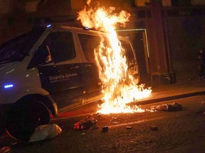 A police van burns during a protest in support of rap singer Pablo Hasel after he was given a jail sentence on charges of glorifying terrorism and insulting royalty in his songs, in Barcelona, Spain, on Saturday.