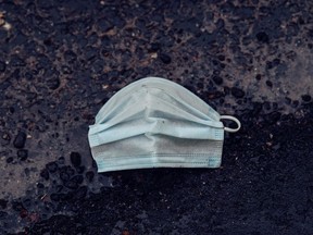 FILE: A protective face mask on the ground.