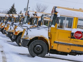 FILE: School buses sit in the snow.